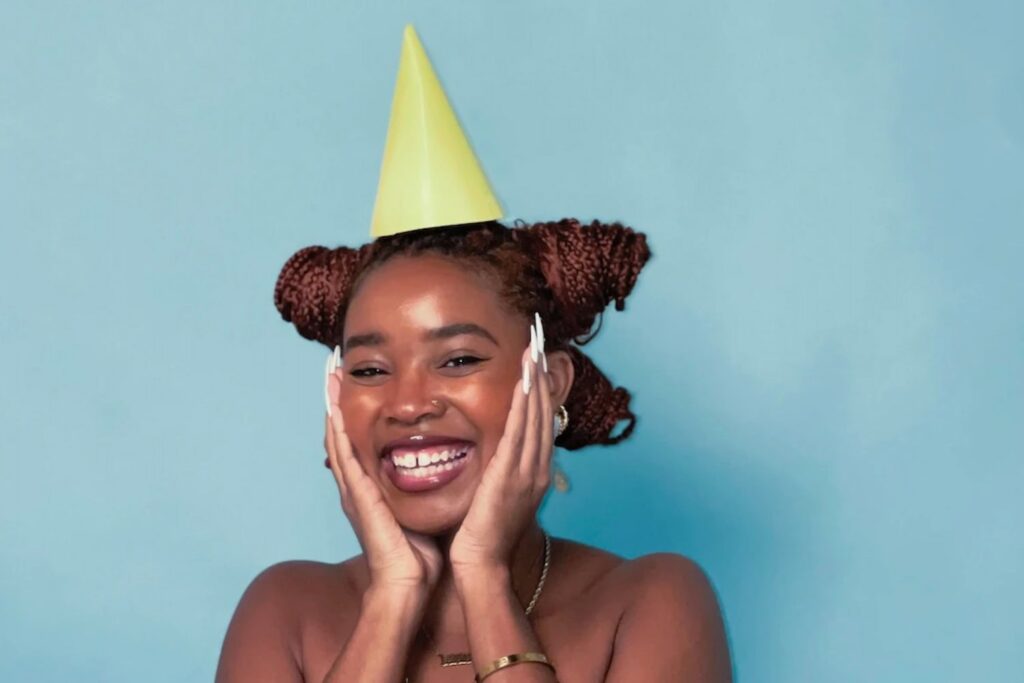 smiling-individual-in-yellow-party-hat-min.jpg